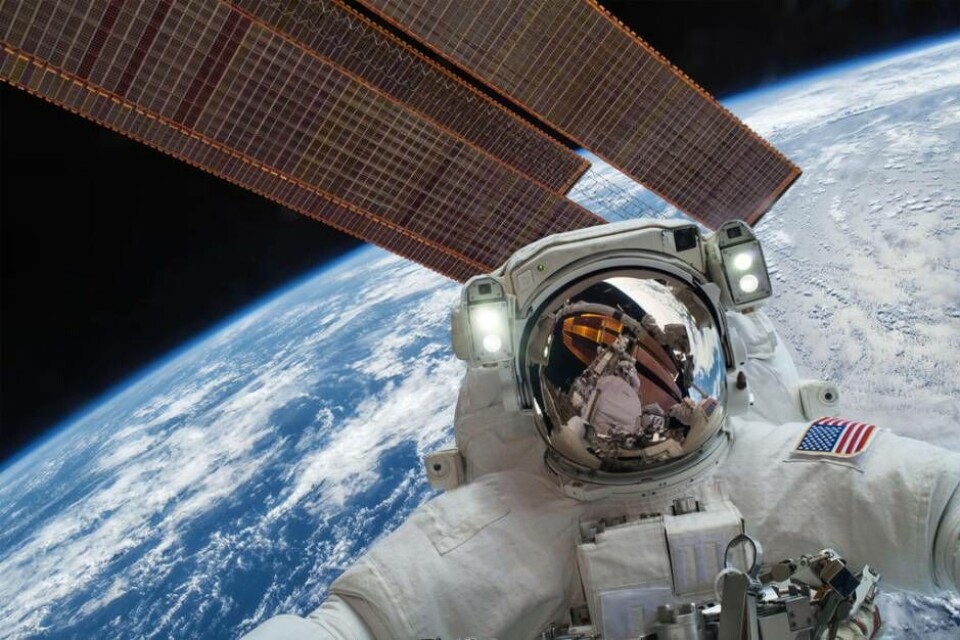 International Space Station and astronaut in outer space over the planet Earth. Elements of this image furnished by NASA.